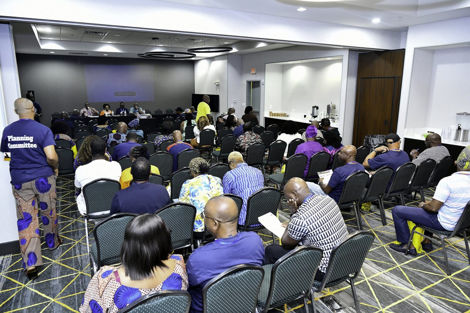 Rows of attendees in the convention room