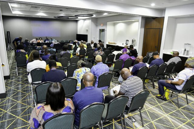 Rows of attendees in the convention room