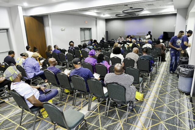 Rows of attendees in the convention room