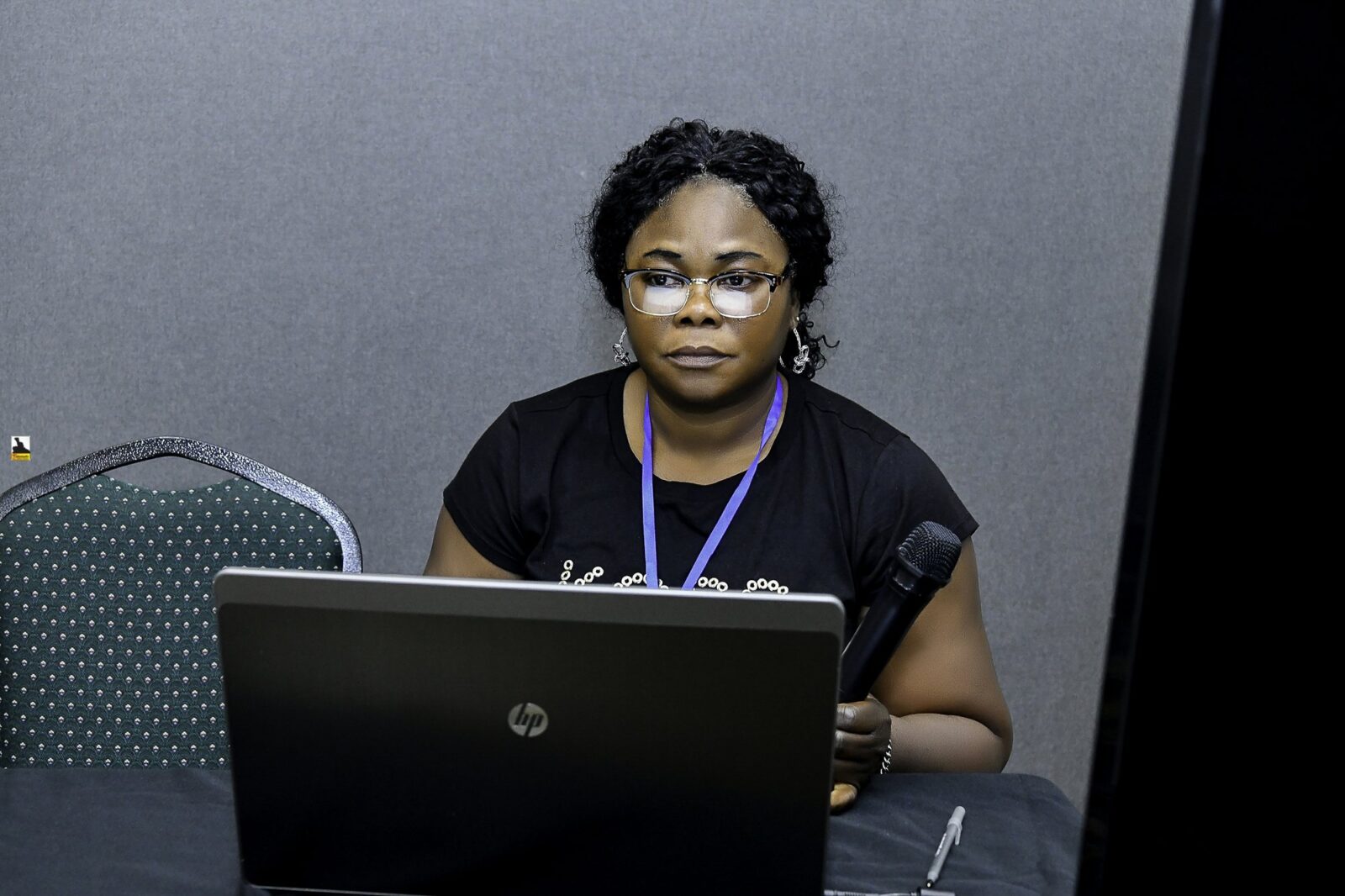Woman seated behind a laptop