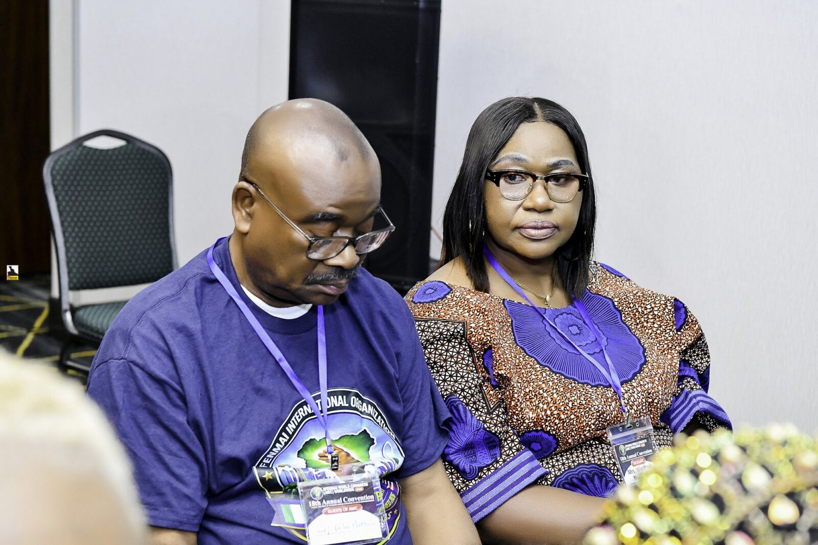 A man and a woman seated together in the meeting room