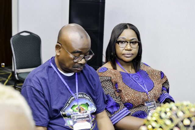 A man and a woman seated together in the meeting room