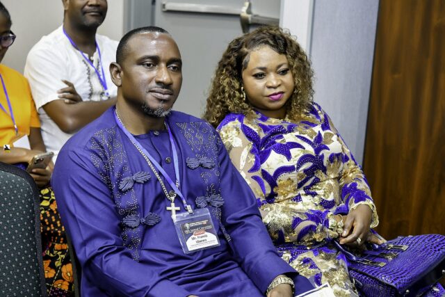 Two attendees in blue clothing seated together