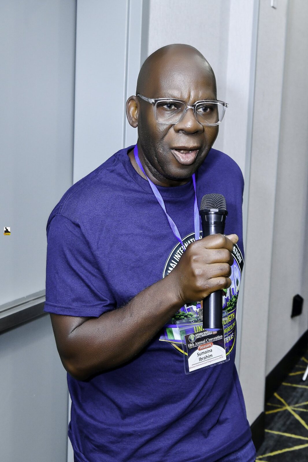 Man holding a microphone in the convention room