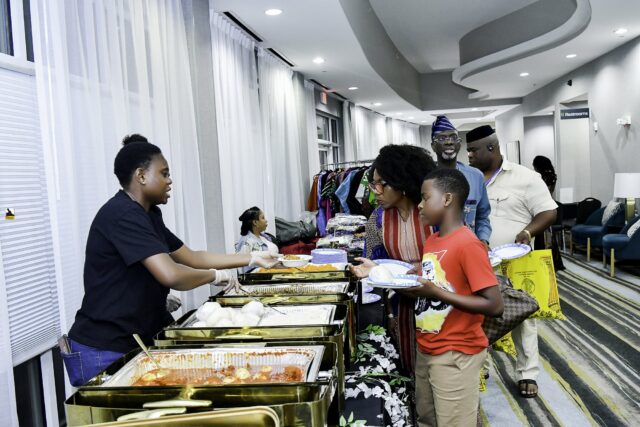 Attendees gathered beside the buffet