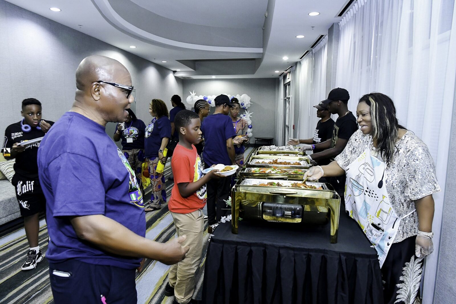 Attendees gathered beside the buffet