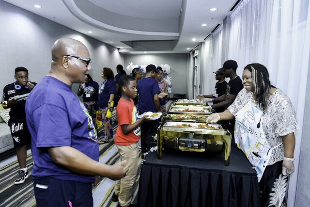 Attendees gathered beside the buffet