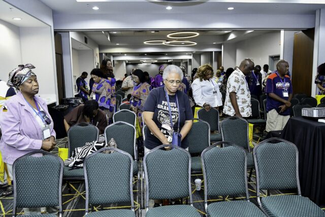 Attendees standing throughout the convention room
