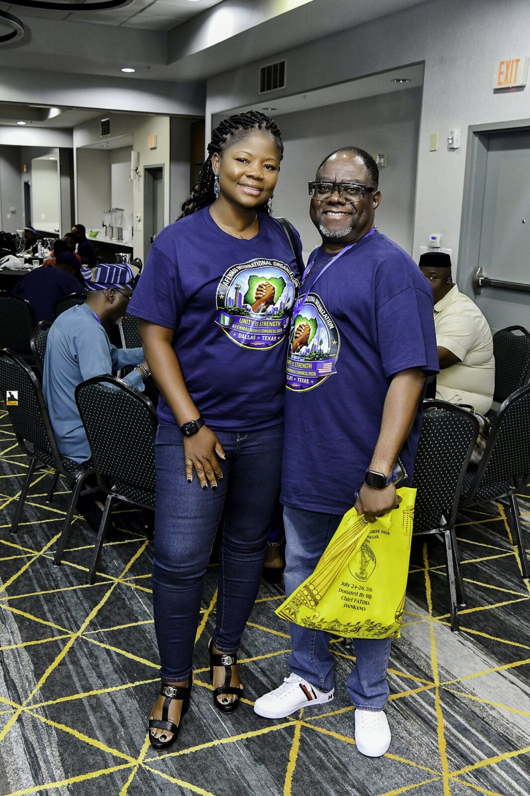 Two women in blue clothing standing together