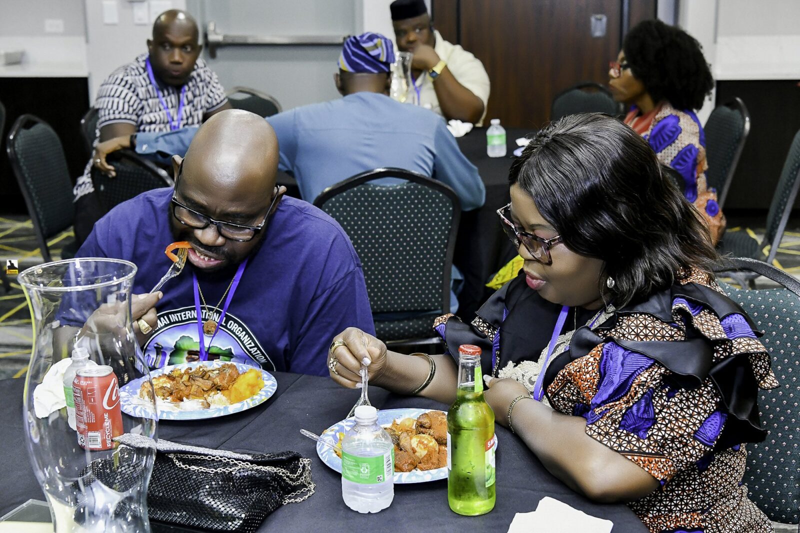Convention attendees eating and talking around a table