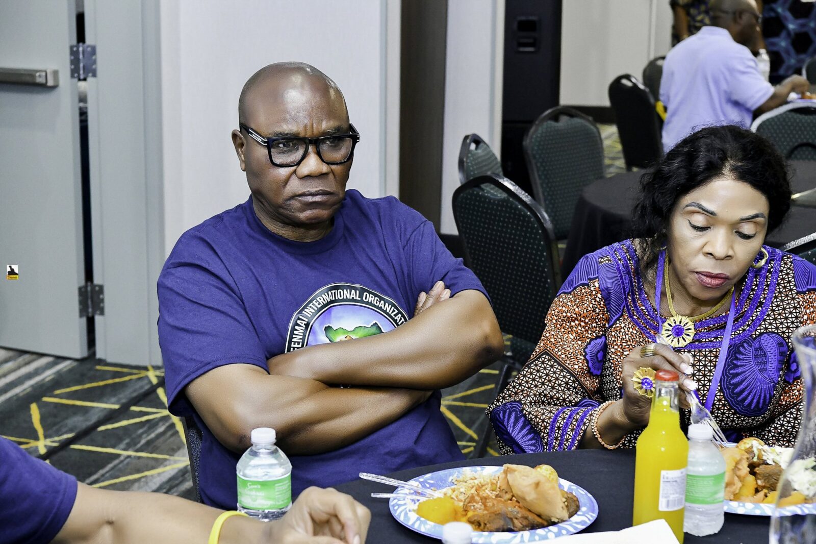 Convention attendees eating and talking around a table