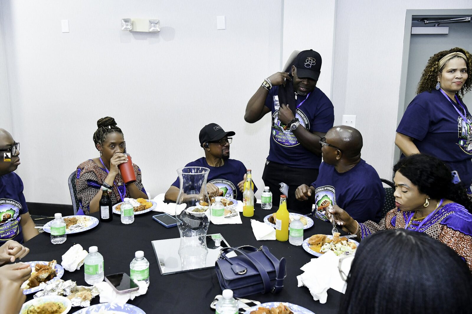 Convention attendees eating and talking around a table