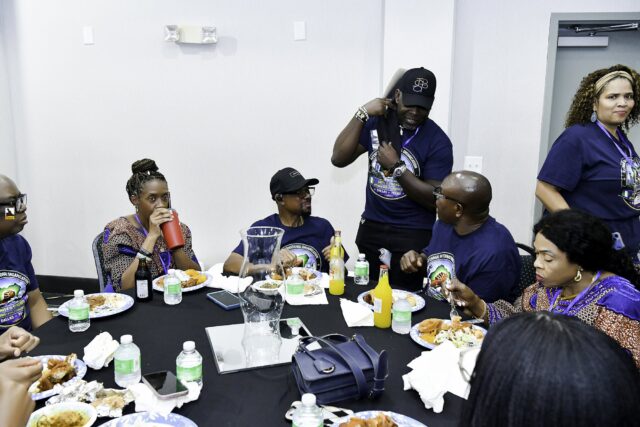 Convention attendees eating and talking around a table