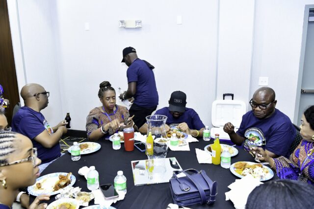 Convention attendees eating and talking around a table