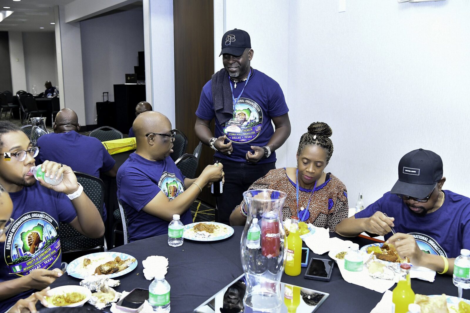 Convention attendees eating and talking around a table