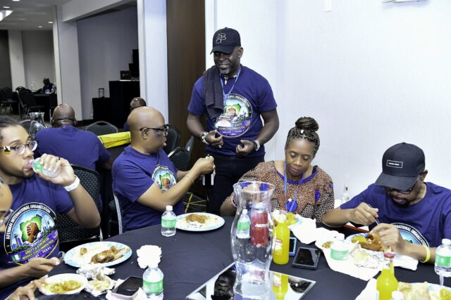 Convention attendees eating and talking around a table