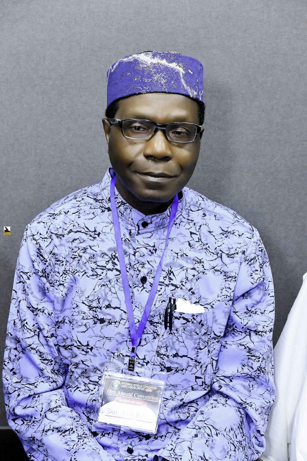 Man wearing a blue patterned cap seated in the room