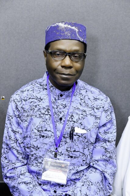 Man wearing a blue patterned cap seated in the room