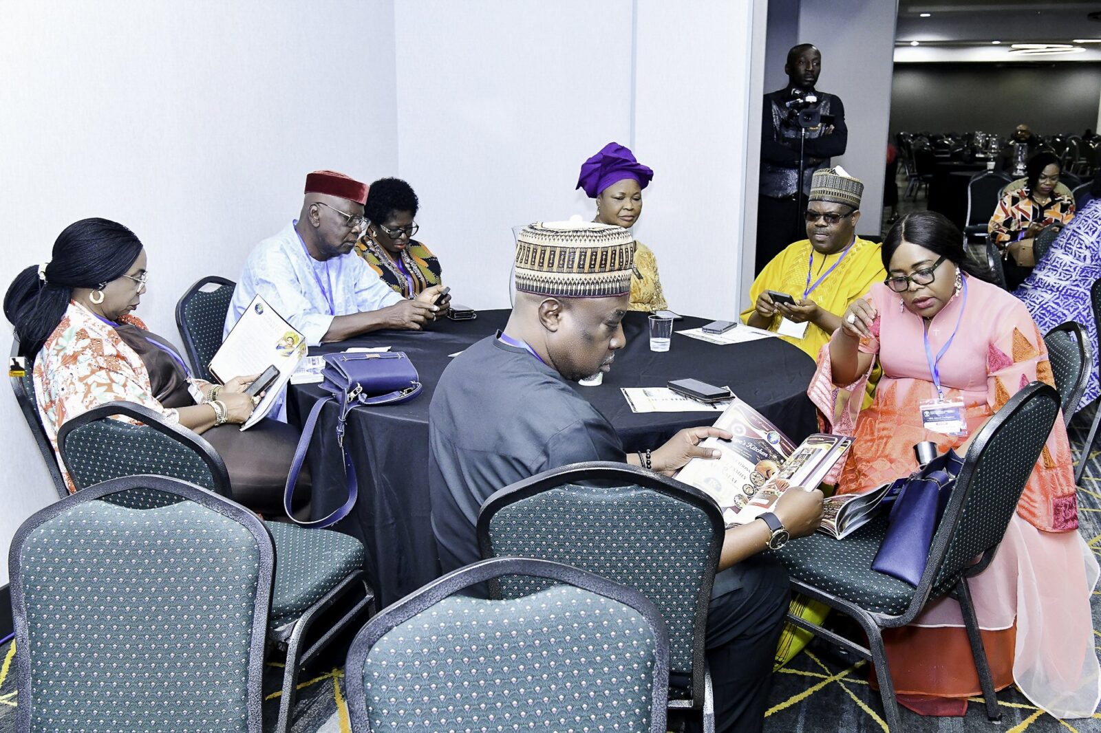Attendees seated together around convention tables