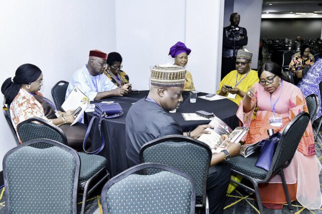 Attendees seated together around convention tables