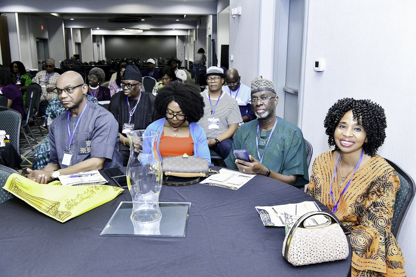 Attendees seated together around convention tables