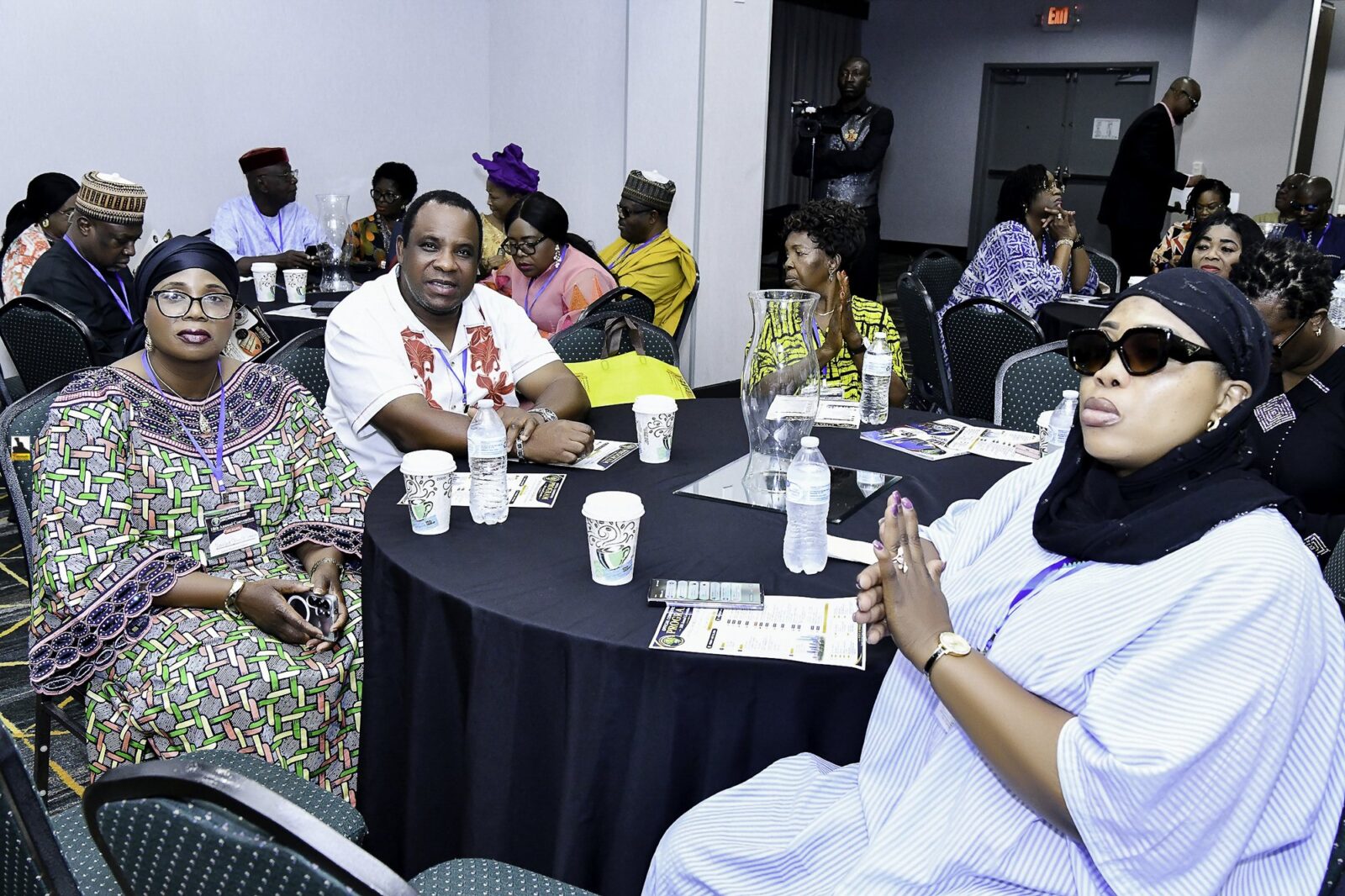 Attendees seated together around convention tables