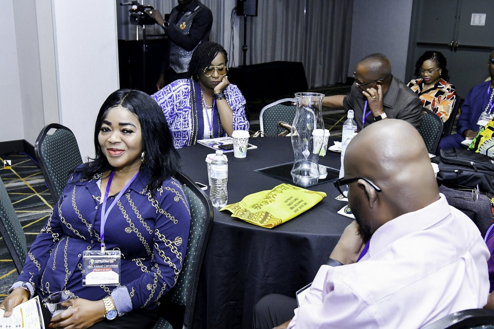 Attendees seated together around convention tables