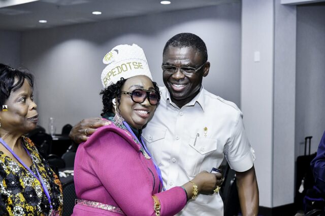 Woman in pink clothing and a white hat beside a smiling man in white