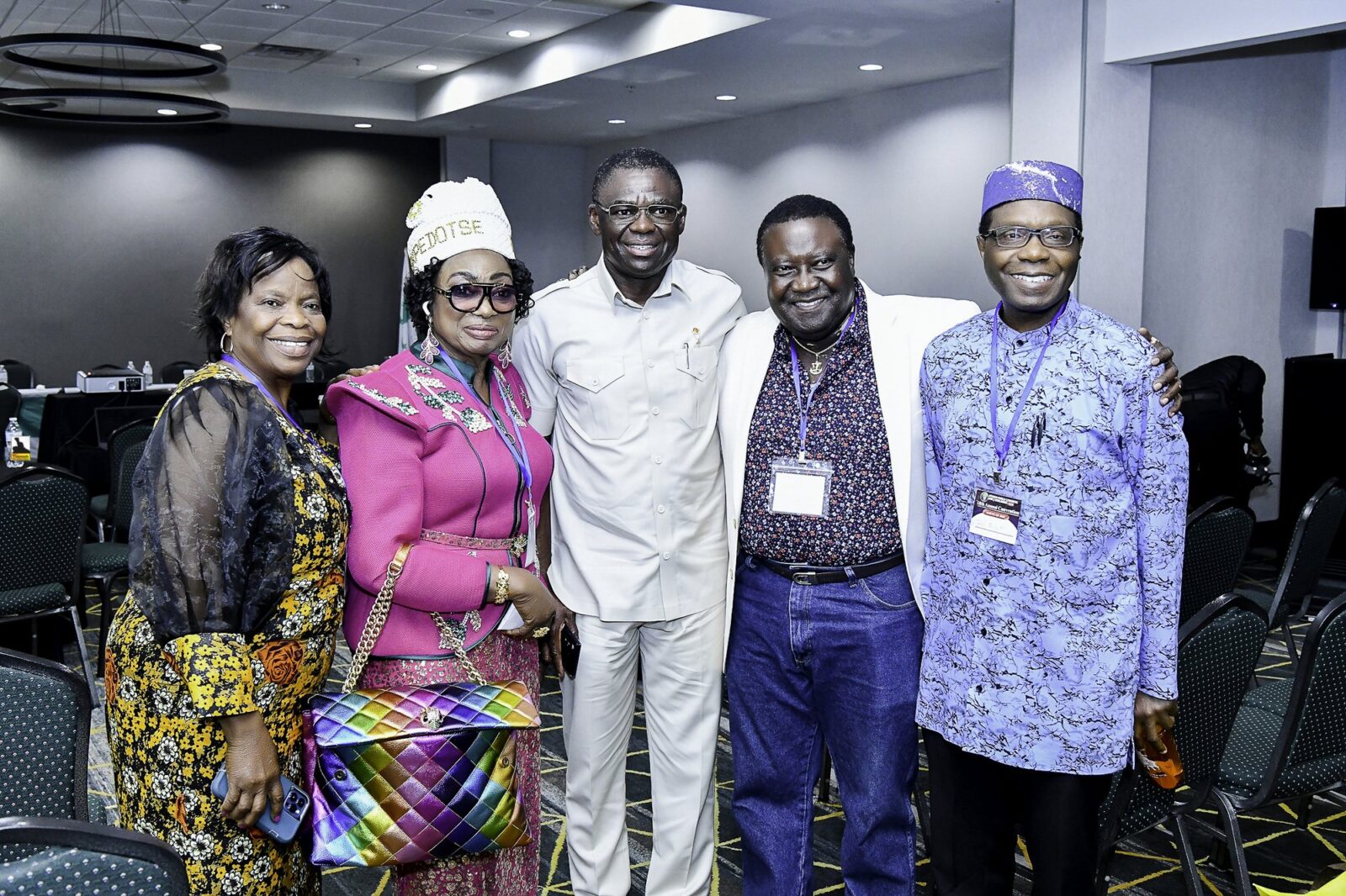 Five attendees posing together in the convention room