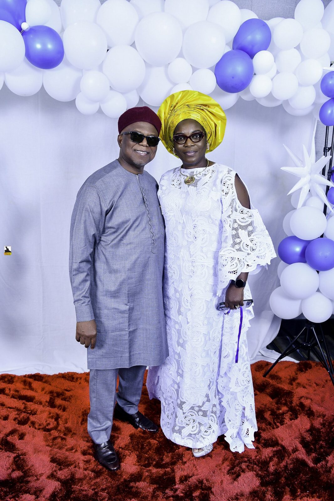 Two attendees in gray and white clothing, one wearing a yellow headwrap
