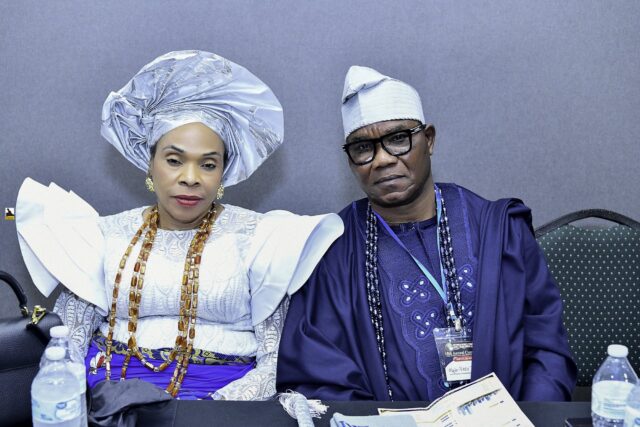 Two attendees in blue and white clothing seated side by side