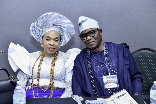 Two attendees in blue and white clothing seated side by side