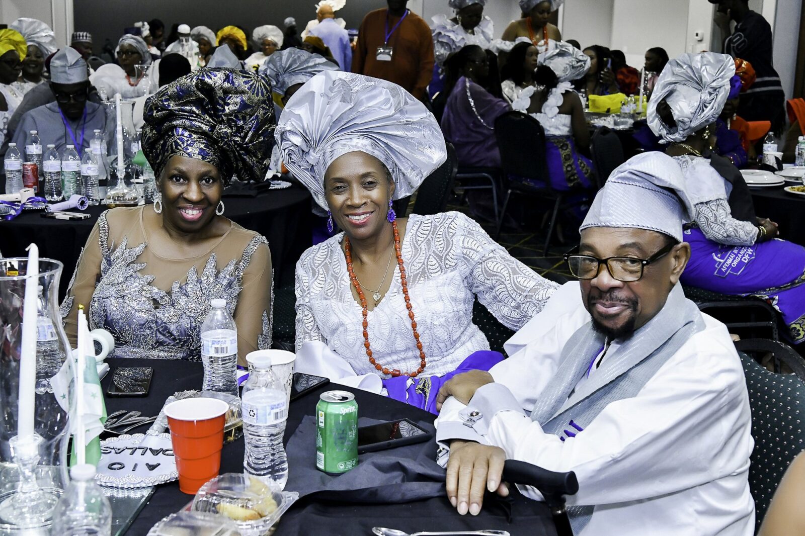 Three attendees smiling around a table