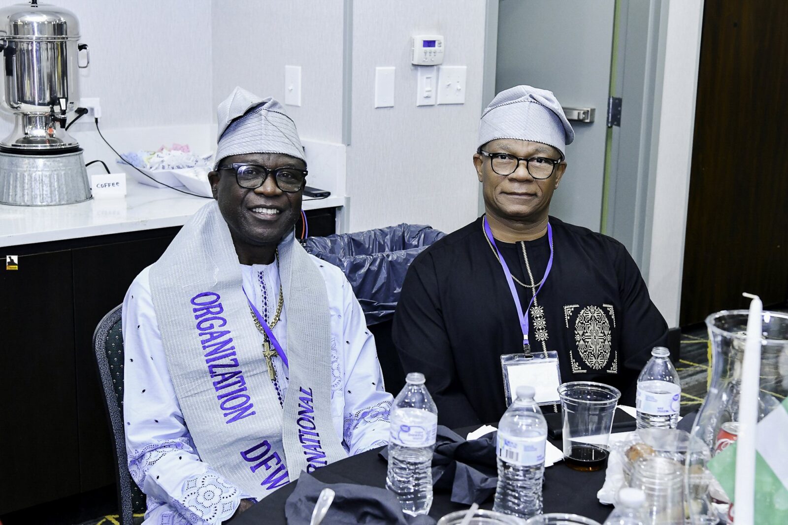 Two men in caps seated together at a table